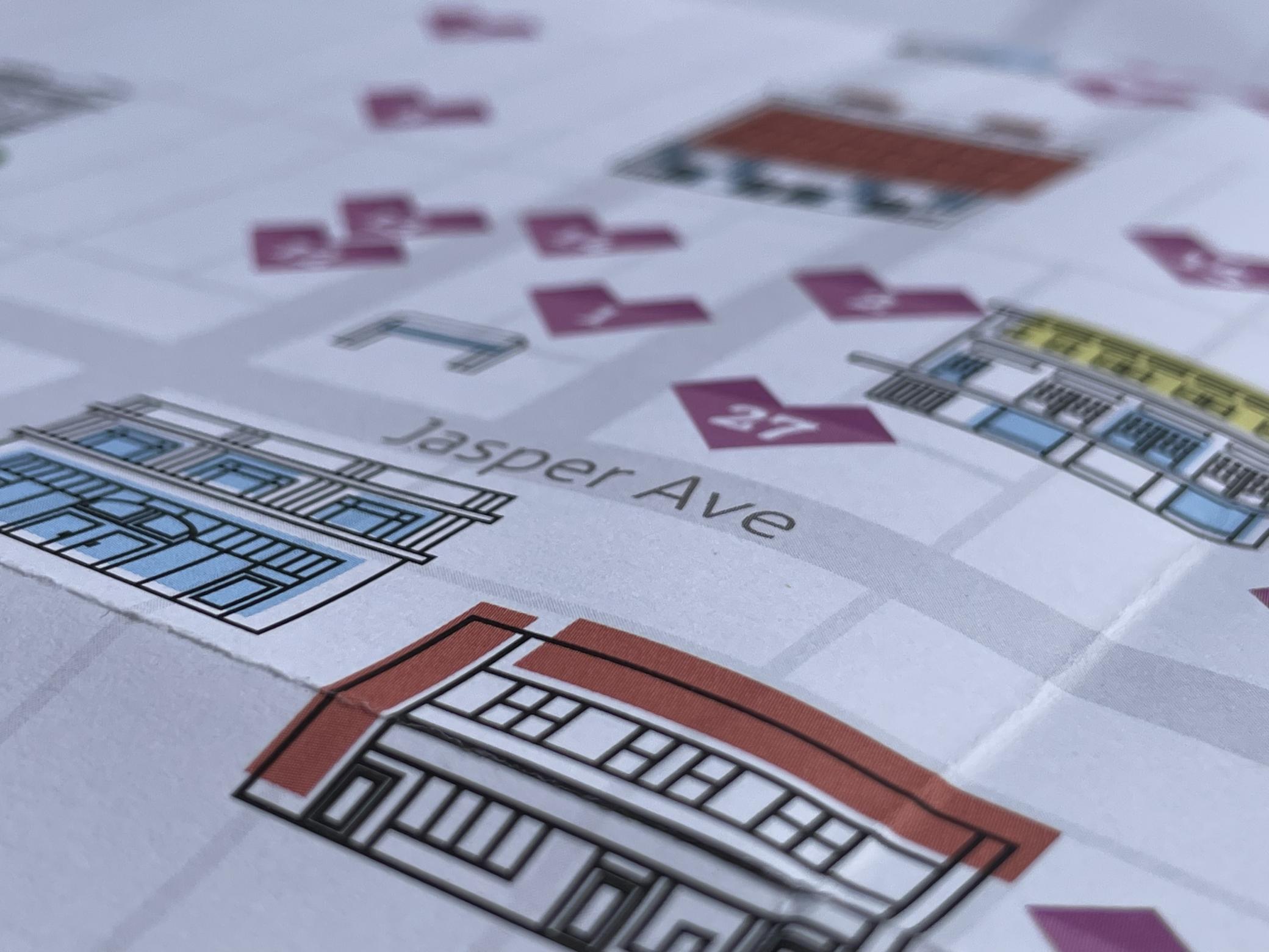 A close-up of the printed map with two buildings on a grid of downtown Edmonton streets, including Jasper Avenue. 