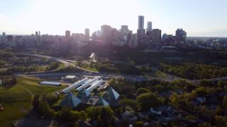 Drone footage of the Muttart Conservatory pyramids, one of Canada's largest indoor botanical collections, with Edmonton’s downtown skyline during the summer.