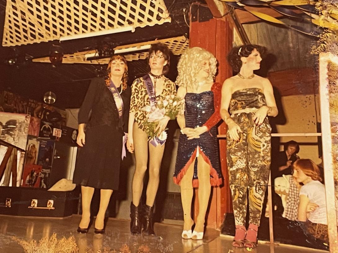Four Ms. Flashback contestants standing on stage. 