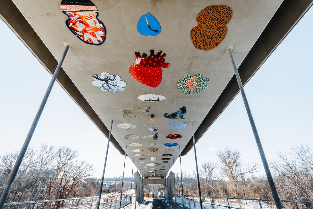 Looking up at the 500-panel art installation on the Tawatinâ Bridge inspired by First Nations and Métis communities in the region.