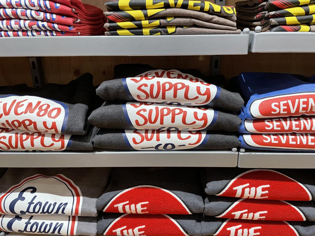Seven80’s t-shirts folded on shelves