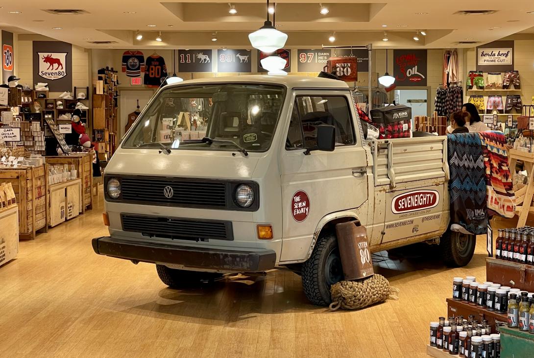 A Volkswagon truck with Seven80 stickers sits in the middle of the store as decor.