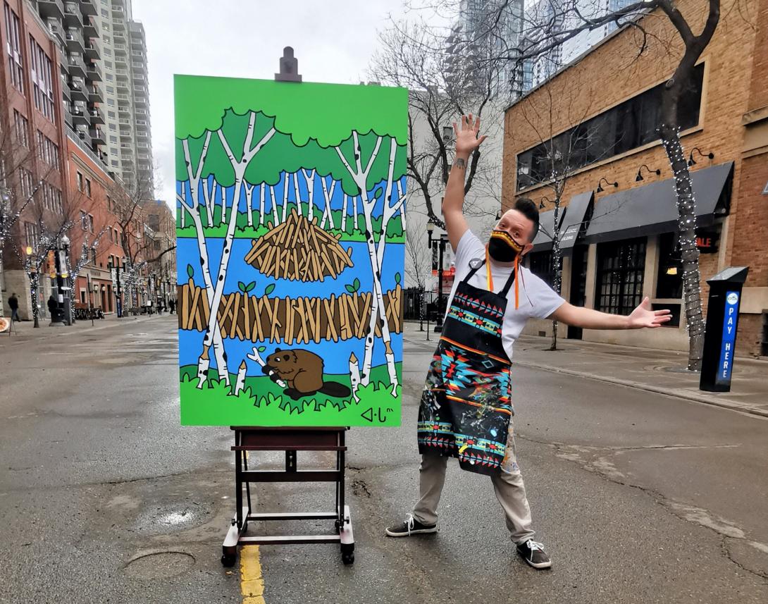 Lance Cardinal stands next to a beaver painting in the middle of 104 Street.