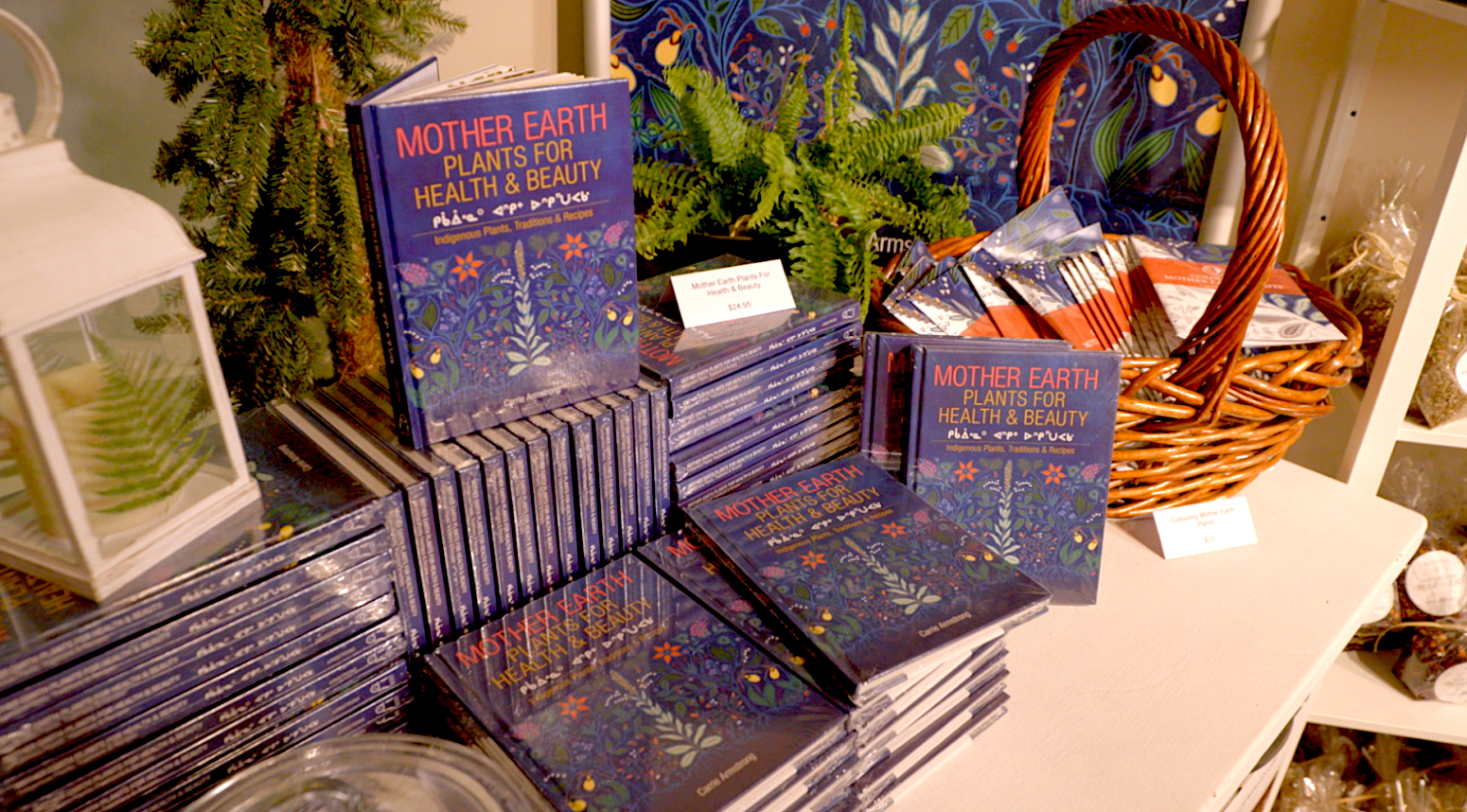 “Mother Earth: Plants for Health and Beauty” books stacked on top of eachother on a table.