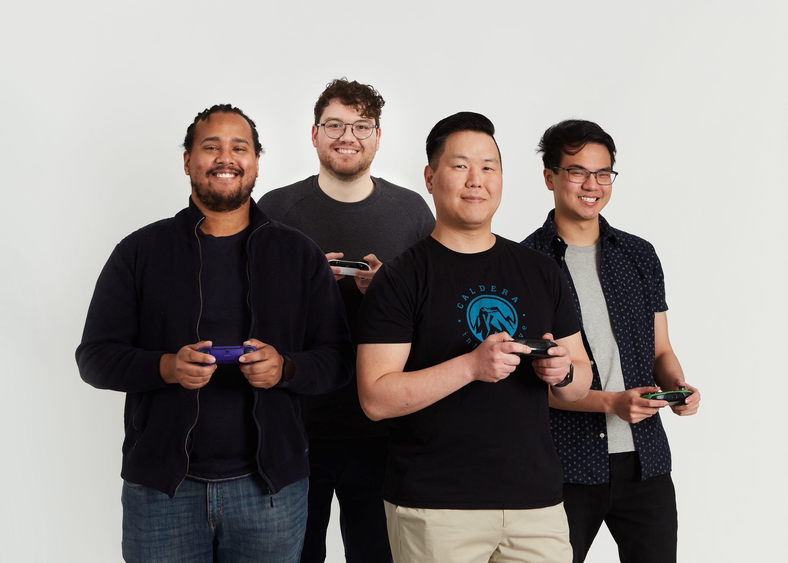 Four men with game consoles in their hands.