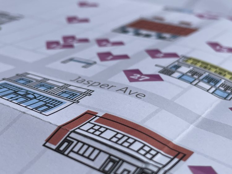 A close-up of the printed map with two buildings on a grid of downtown Edmonton streets, including Jasper Avenue.