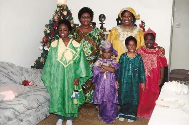 An undated photo of Sarah Adomako-Ansah, her siblings in traditional Ghanaian clothing. Two female family members stand behind them.