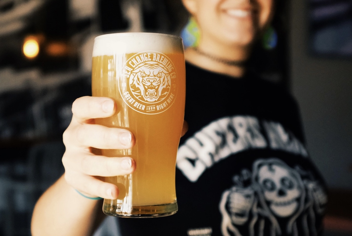 person holding beer with focus on the pint