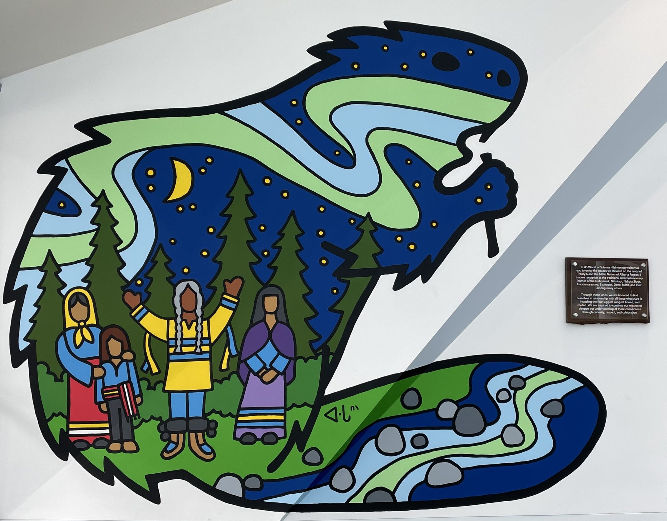 Lance Cardinal’s mural features a beaver, four Indigenous people, the moon, stars, northern lights, trees, earth, and water.