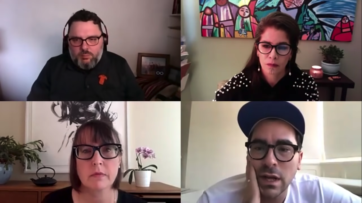 Screenshot of a Zoom call with four participants. Top left is a man with headphones and glasses, top right is a woman with glasses and a painting in the background, bottom left is a woman with glasses and a flower pot in the background, and bottom right is a man with glasses and a cap.