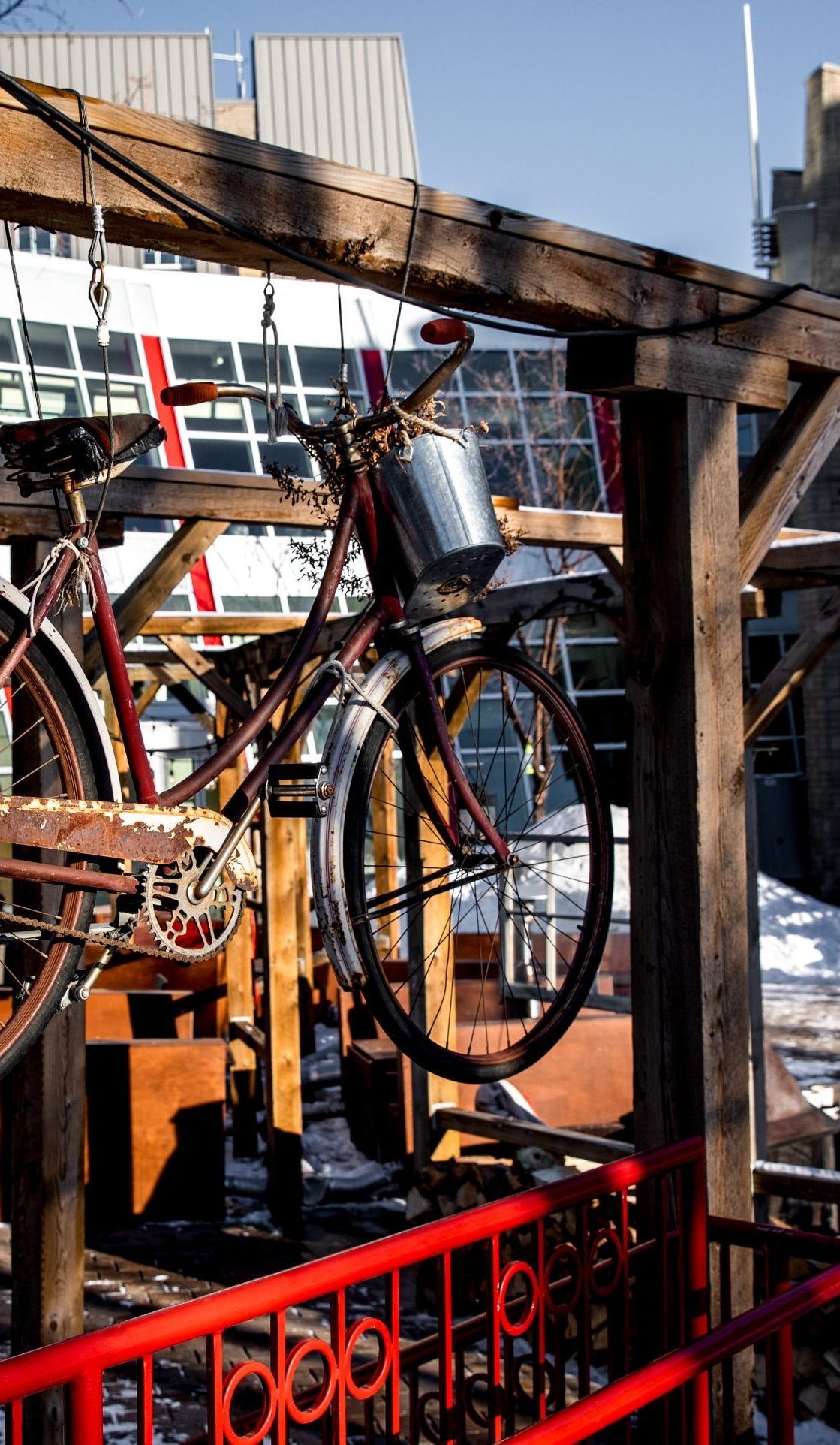 The Café Bicyclette patio with a bicycle with a basket planter on the front hangs as decor.