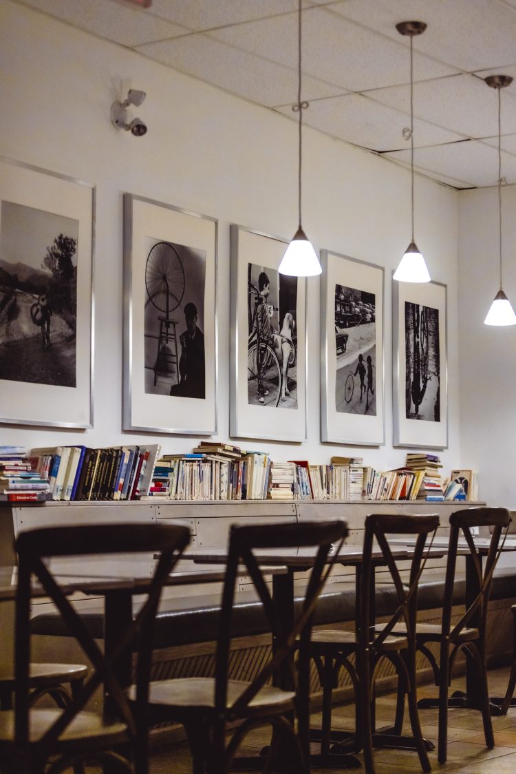 Tables, books and decor inside local restaurant Café Bicyclette