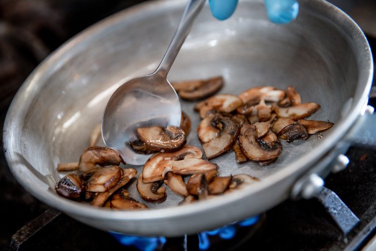 Chef at Café Bicyclette cooking mushrooms