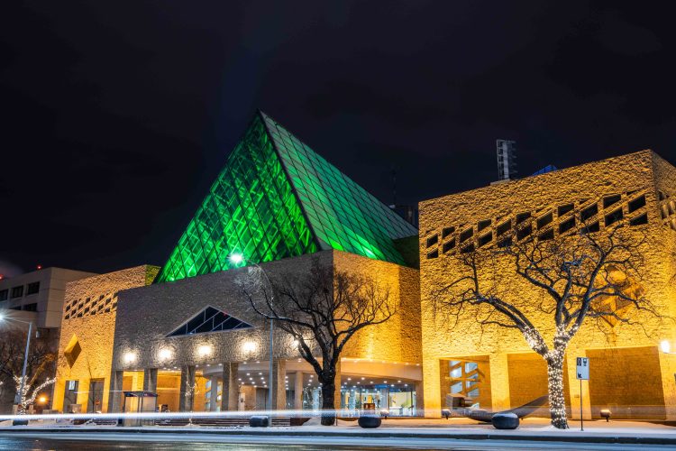 City Hall pyramid lit up in green at night