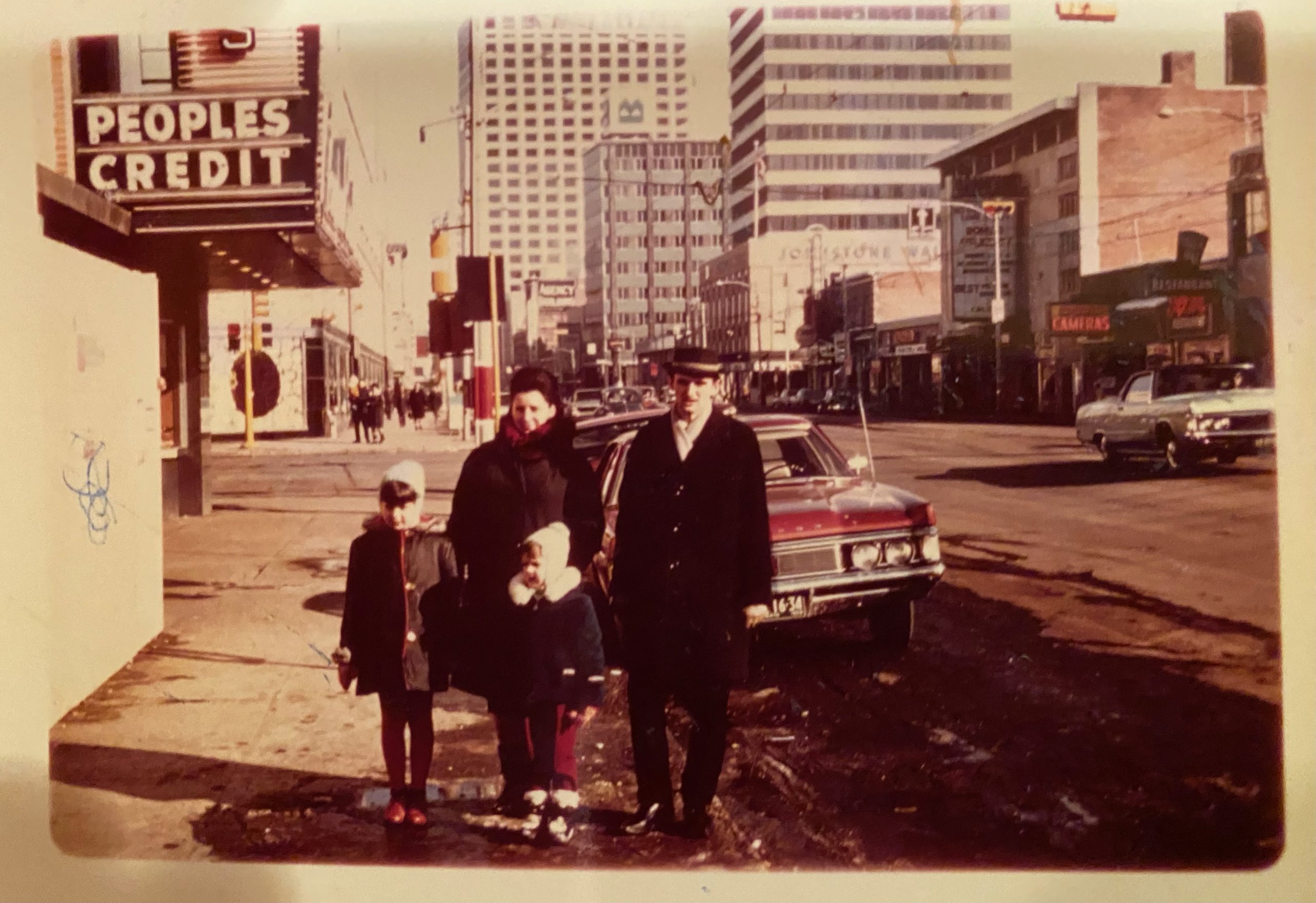 An old photograph of Slavo and his family standing on a street in downtown Edmonton in 1969.