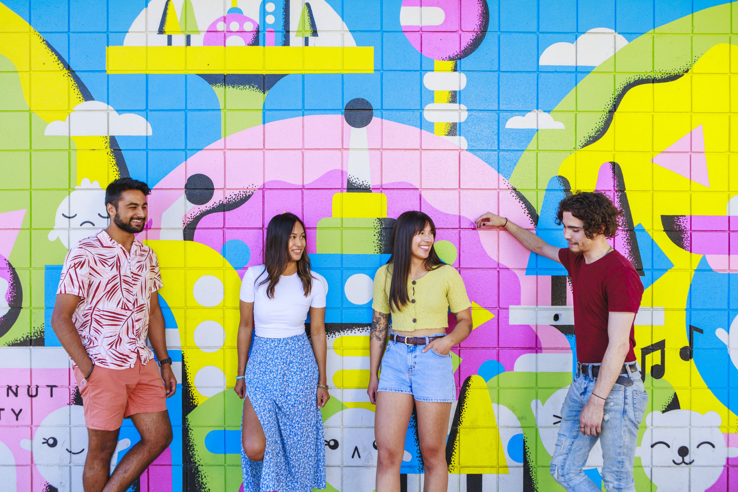 Friends talking by the mural in Ritchie