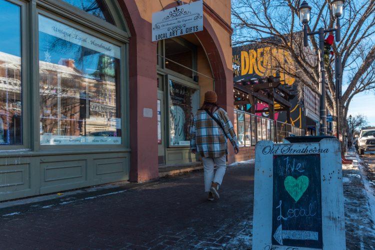 A person shops along Whyte Avenue on a winter day