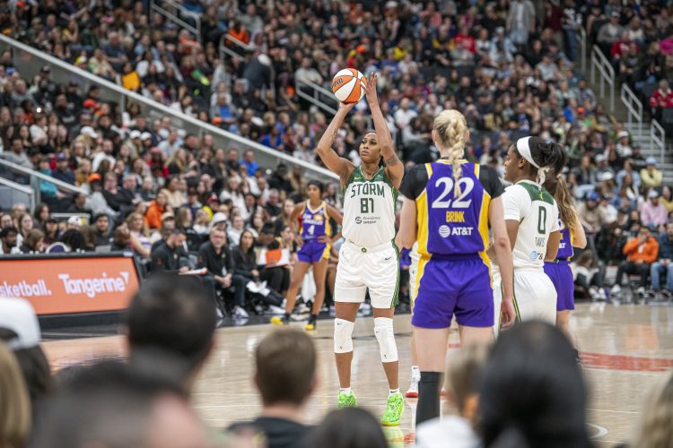 WNBA player shoots a free throw in a packed stadium.