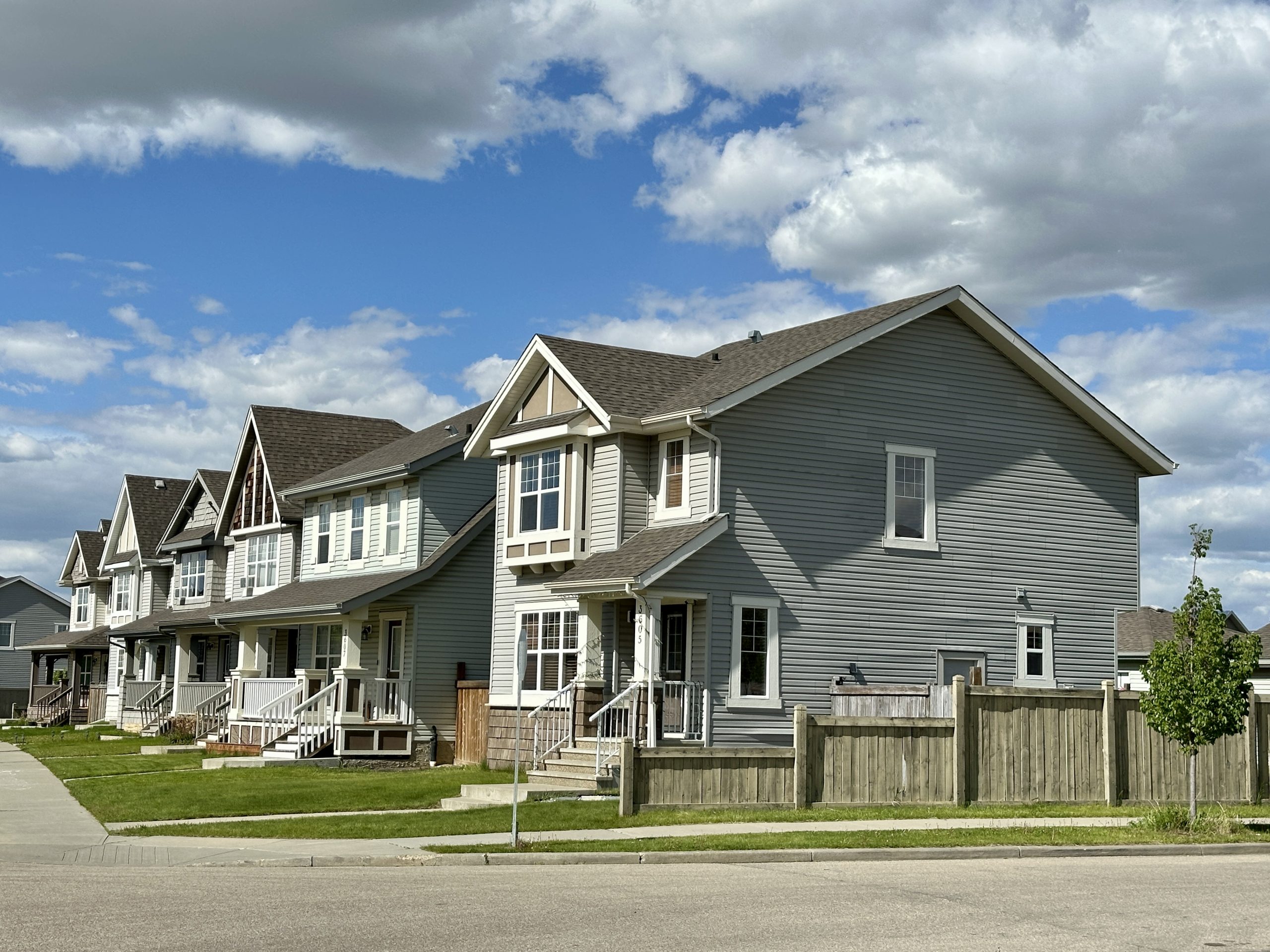 A row of five grey and beige homes.