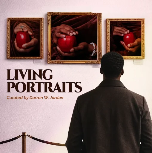 The back of a black man looking at 3 pieces of art hanging on a wall.