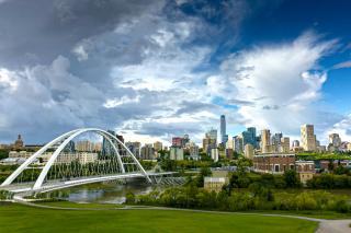 The Edmonton skyline features downtown highrises, the arched Walterdale Bridge and the green of the river valley.