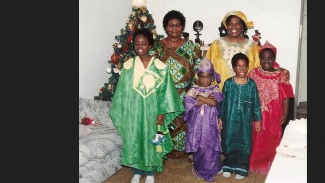 An undated photo of Sarah Adomako-Ansah, her siblings in traditional Ghanaian clothing. Two female family members stand behind them.